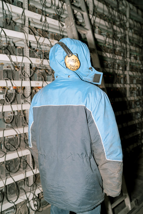 Mine worker wearing thermal clothing and hearing protection. Location: Irkutsk, Russia